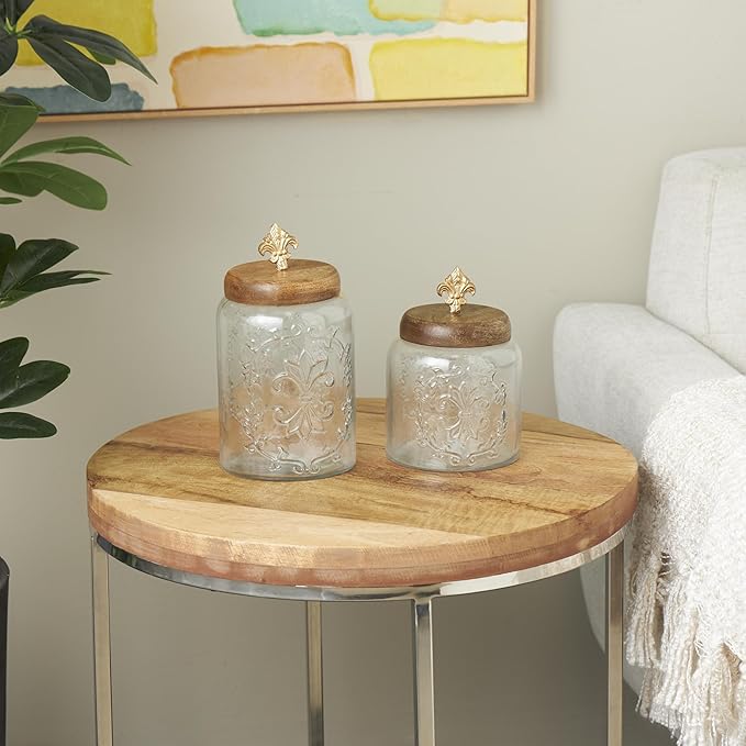Deco 79 Glass Scroll Living Room Decorative Jars Decorative Container with Brown Wooden Lids and Gold Fleur-De- Lis Knobs, Set of 2 Jar with Lid 9", 7"H, Clear